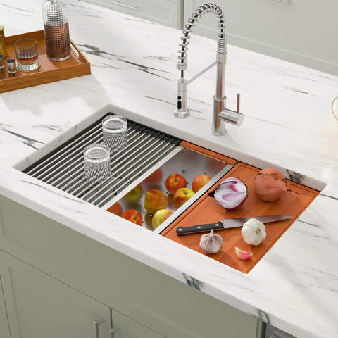 Undermount 33 Inch Stainless Steel Workstation Kitchen Sink Heavy-Duty 16 Gauge 304 Handmade Welded Construction With Accessories Round Corner Brushed Wear-Resistant Finish Deep Single Bowl Measures 33x19x10 Inches Model DCU7701 in a modern kitchen setup with integrated accessories and fruits.