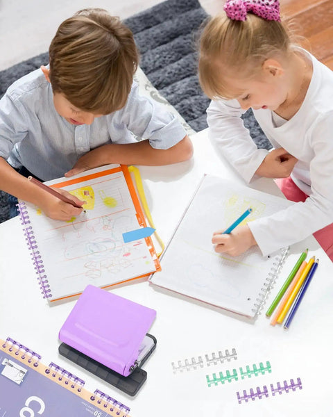 Children drawing with planners beside a purple 10 Hole Binding Punch For Planners, Metal Manual Puncher For Home Office