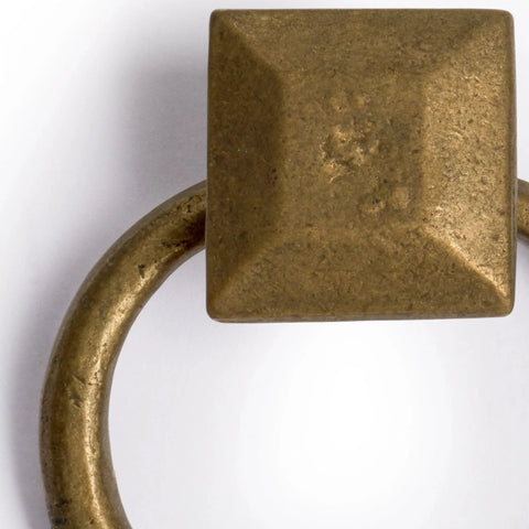 Close-up of solid brass peg and ring pull with square mount holder, ideal for architectural interior design and furniture customization.