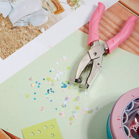 Three Piece Hole Punch Set With Circle Heart And Star Shapes Includes One Quarter Inch And Three Sixteenths Inch in action on paper.