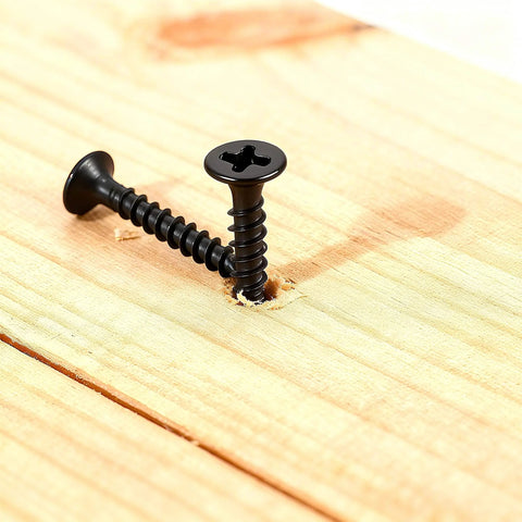 105 Piece Wood Screws Set With Black Oxide Finish And Phillips Drive, one screw partially installed in wood surface
