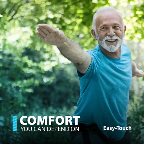 Older man in athletic pose in a green park, wearing a blue shirt, promoting Easy Touch comfort and reliability.