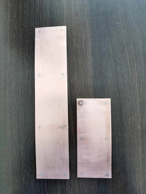 Magnetic Copper Welding Spoon Backing Set For Butt Welds Two 5 Inch Copper Panels shown from above on dark surface