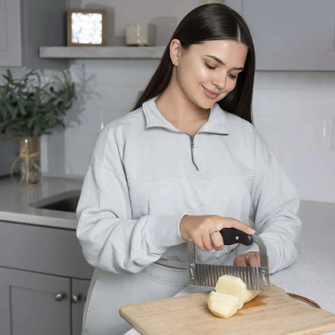 Woman using Crinkle Cutter For Veggies And Fruits, Wavy Slicer For Waffle Fries, Chips, Pickles, And More, Durable Stainless Steel Kitchen Gadget By Fox Run in kitchen
