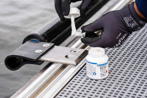 Applying Anti Seize High Tech Metal Free Assembly Paste For Clean DIY And Pro Use NSF Certified Prevents Seizing And Corrosion Safe On Stainless Steel And Food Equipment Extreme Heat Range From -40 F To 2552 F 4.2 Oz to a stainless steel part on equipment.