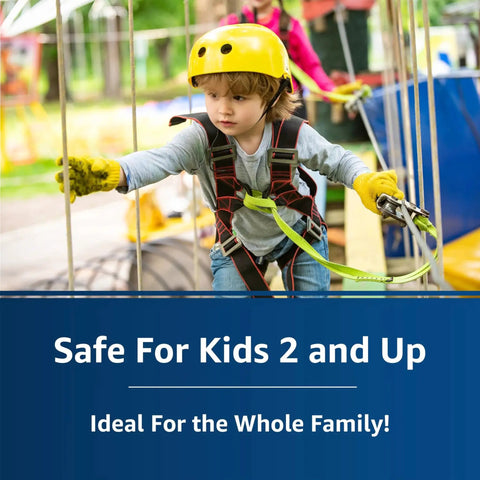 Child in safety harness and helmet on adventure course labeled 'Safe For Kids 2 and Up, Ideal For the Whole Family' outdoors.
