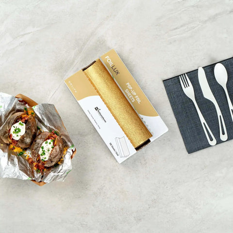 Gold Embossed Pop-Up Foil Sheets 10.8 X 9 Inch with baked potatoes in foil and dining utensils