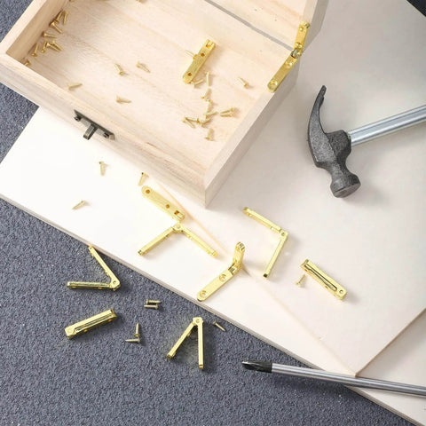 Gold Zinc Alloy Jewelry Box Hinges Set, 10 Pcs 90 Degree Small Hinges With 40 Screws on table next to wooden box and hammer