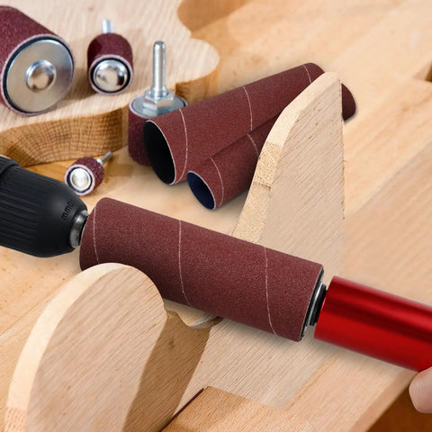 Installed spindle sander drum adapter on drill with burgundy rubber sanding sleeves, shaping curved wood edge.