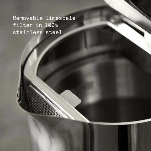 Close-up of stainless steel electric kettle with removable limescale filter, showing double wall design and interior detail.