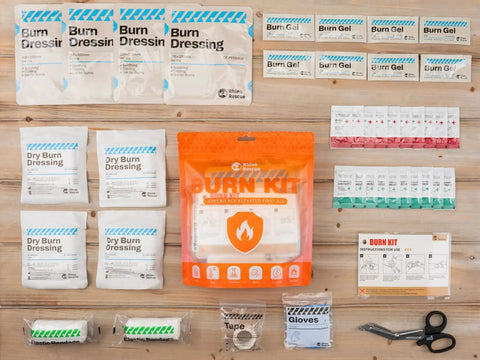 All In One Burn Care Kit From Rhino Rescue with dressings, burn gel packets, burn pads, cream, gloves, scissors, and tape displayed.