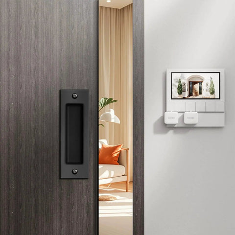 6 Inch Flush Pull Sliding Barn Door Handle Set on wooden door, recessed rectangular plate in matte black, installed, room background