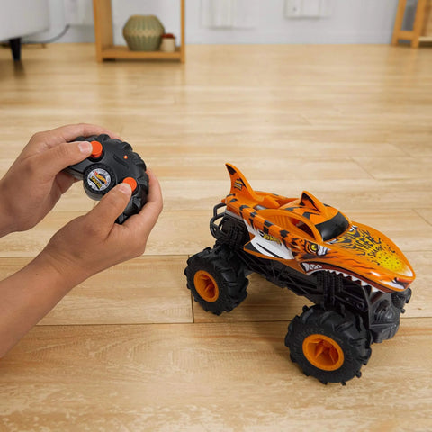 Monster Trucks RC Tiger Shark One Twenty Four Scale Remote Control Truck With Terrain Action Tires on wooden floor