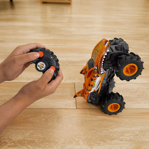 Monster Trucks RC Tiger Shark One Twenty Four Scale Remote Control Truck With Terrain Action Tires in use on wood floor