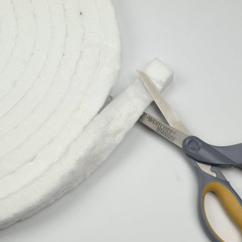 White ceramic fiber blanket strip, 1 in wide x 1/2 in thick, 300 in long, cut with Westcott Titanium scissors.