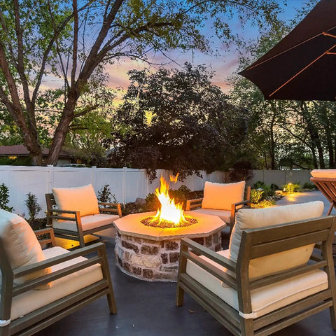 Outdoor patio with fire pit surrounded by comfortable chairs, suitable for use with high pressure 0-30 PSI adjustable propane regulator kit.