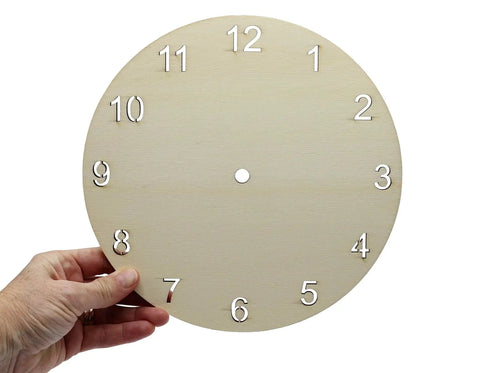Unfinished Wood Clock Face for Crafts 9 Inch Round Blank with Laser Cut Numerals held by hand, ready for DIY projects.