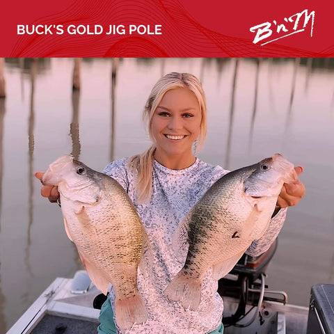 Angler holding two large fish caught with Buck's Gold Jig Pole in boat at sunset, showcasing successful fishing trip.