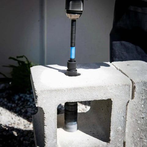 12 Inch Dual Hex Eight And Hex Ten Locking Hole Saw Extension Chuck For Power Drills being used on concrete block