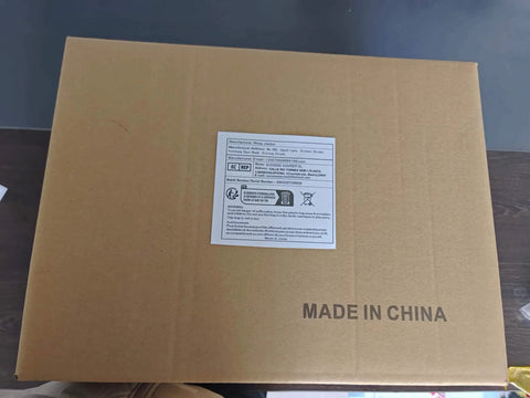 Cardboard packaging box with product label and 'Made in China' text on the surface, on a dark table background.