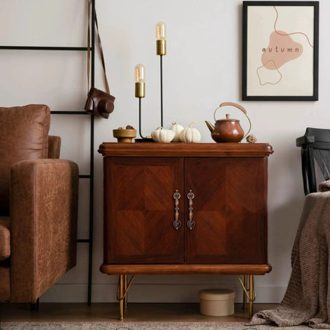 Wooden cabinet with decorative handles, surrounded by fall decor and a cozy room setting; no visible cabinet pulls from the product description.