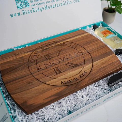 Personalized Wood Cutting Board With Gift Box, Stand, And Oil Included For Weddings, Anniversaries, Birthdays Or Mothers Day, Laser Engraved And Custom Engraved In Cherry, Maple, Or Walnut For Her By Blue Ridge Mountain Gifts displayed in open box with oil and stand.