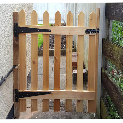 Wooden gate with 2 Inch T Strap Hinges Six Pack Heavy Duty Black Carbon Steel With Screws, installed outdoors, showcasing durability.