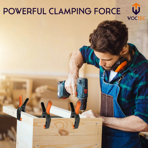 WOCTEC 4-pack 6-inch plastic woodworking spring clamps with orange grips on a wooden box