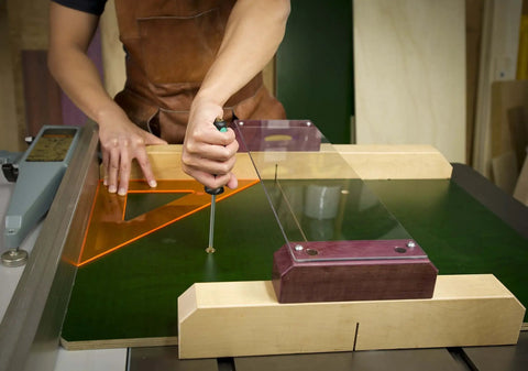 Using ZeroPlay Miter Bars 2-Pack with MatchFit Jig Handle on a table saw sled, demonstrating top-down mounting system