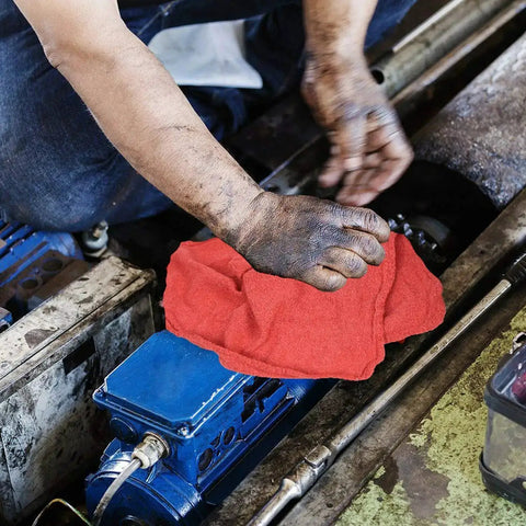 Mechanic using heavy duty shop towels 50 pack cotton rags 14 by 14 inches lint free commercial grade red for auto repair.