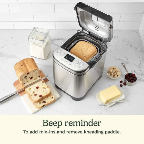 Stainless Steel Automatic Bread Maker With 12 Menu Presets 3 Crust Colors And 3 Loaf Sizes Up To 2 Lb Removable Nonstick Pan And Kneading Paddle shown with fresh bread slices and ingredients.