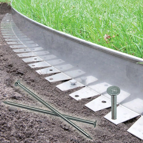 Heavy Duty 6 Inch Metal Nails 144 Pack Landscape Anchoring Spikes For Paver Edging Weed Barriers Turf Tent Stakes And More Ideal For Yard Construction Carpentry Projects, shown securing landscape edging in garden soil