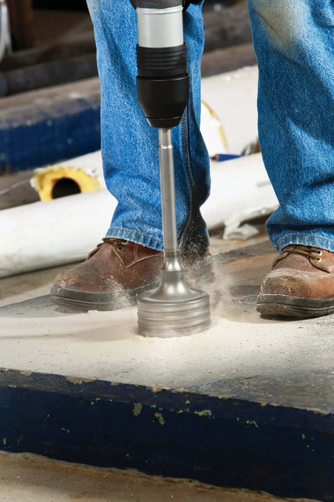 Beefed-Up 6-Inch 2-Piece Rotary Hammer Core Bit in use for drilling concrete, showing wave design and carbide tip
