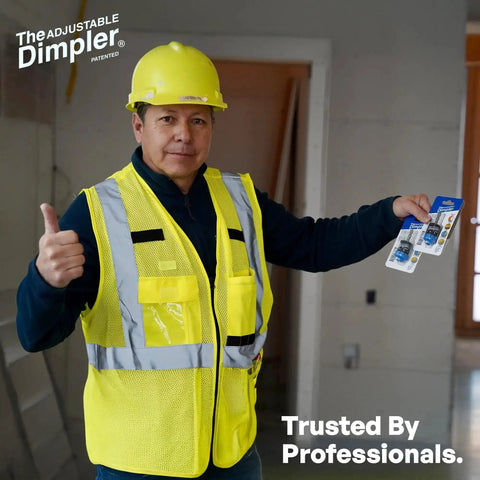 Construction worker holding Adjustable Drywall Bit And Screw Gun Attachment with magnetic bit holder in a building site.