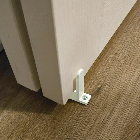 4 Pack Universal ABS Sliding Closet Door Floor Guides for 1-3/8 Inch Thick Doors White Bottom Guides With Screws Keeps Sliding Panels Centered On Tracks Provides Side Support For Cabinet And Closet Door Systems installed view