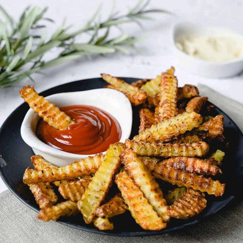 Crispy fries with crinkle cuts made using Triangle Crinkle Cutter With Ultra Sharp Stainless Steel and ketchup dipping sauce.