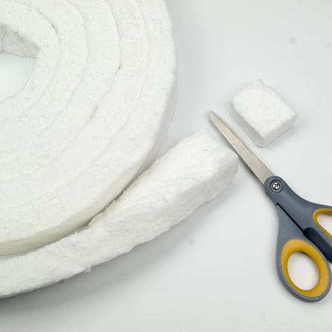 Lynn Manufacturing white ceramic fiber blanket roll with cut strips and small blocks; scissors beside.