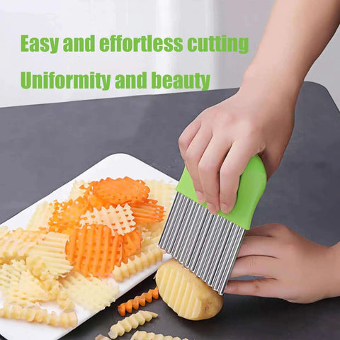 Person using 4 Pcs Crinkle Cutter Set For Fries And Veggies With Waffle Wave Fry Cutters, chopping potatoes on a cutting board.