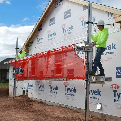 Workers installing Pump Jack Safety Net 22 Ft Nylon Guard Rail for Stages OSHA Compliant on residential construction site.