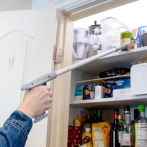 Person using 32 Inch Grabber Plus Reacher Tool With Built In Magnet For Trash Pickup And Yard Cleanup Ergonomic Trigger Grip Claw in kitchen