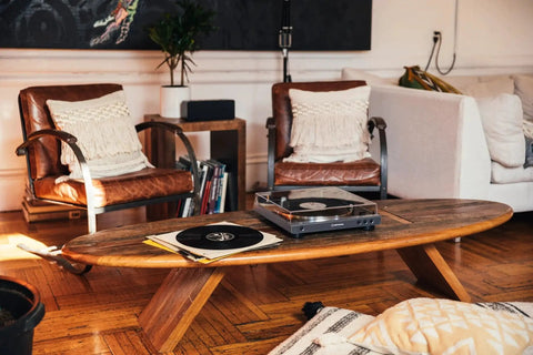 Fully Automatic Bluetooth Belt Drive Turntable With AptX, wirelessly streams, on a wooden table in a living room setup
