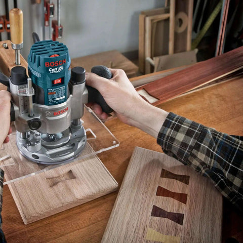 Person using Bosch router with 15 Piece Micrograin Carbide Tipped Wood Router Bit Set for shaping wooden panel.
