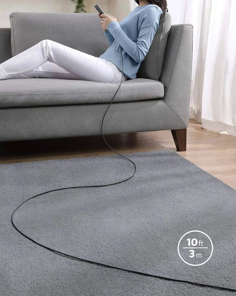 Person using USB C to USB C Cable 10 Foot 100W Fast Charge Nylon Braided for iPhone MacBook on a sofa