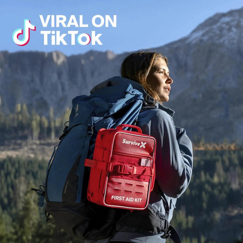 Hiker with Large Pro First Aid Kit For Car Travel And Home on mountain trail