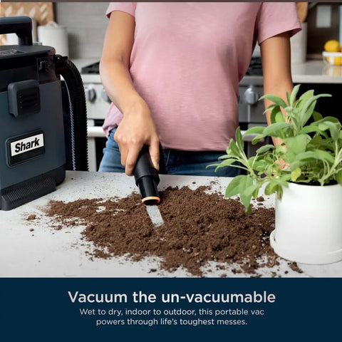 Person using MessMaster Portable Wet Dry Vacuum One Gallon Capacity With True Grip Accessory Suite Corded For Pets And Cars Ultra Powerful Suction For Tough Wet And Dry Messes Burgundy UV105 on a kitchen counter to clean soil.