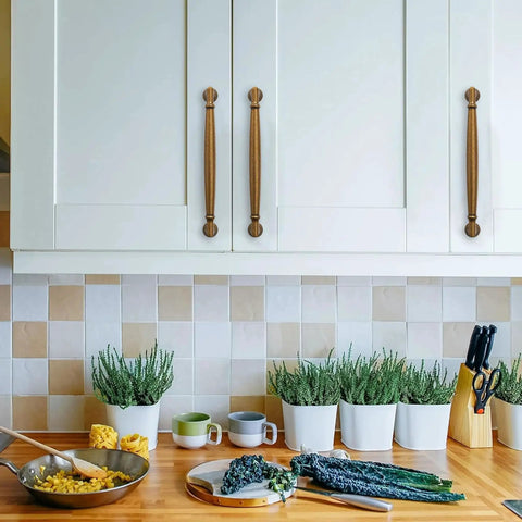 Antique Brass Cabinet Pulls 3.5 Inch Hole Center Solid Zinc Alloy Handles installed on white kitchen cabinets above a wooden countertop.