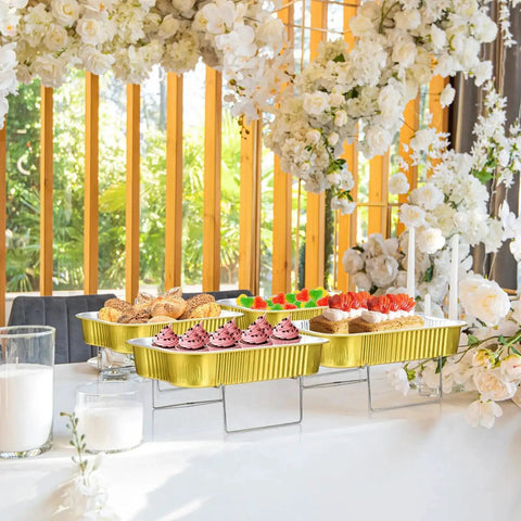Four Sets Disposable Chafing Dishes Buffet Set with Chafer Wire Racks on decorated table, aluminum pans with lids for parties, large fuel not included.