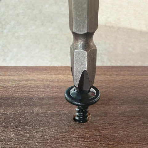 Size 8 By 0.75 Inch Black Phillips Modified Truss Head Wood Screw being driven into wood surface
