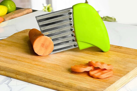 Two-Piece Stainless Steel Crinkle Cutter Set For Fries And Wavy Chips Veggies And Fruits with carrot on a wooden board.