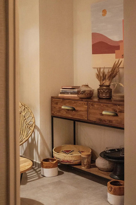 Decorated nook with wooden cabinet featuring antique brass cabinet pulls 5 inch center to center and decorative chair.